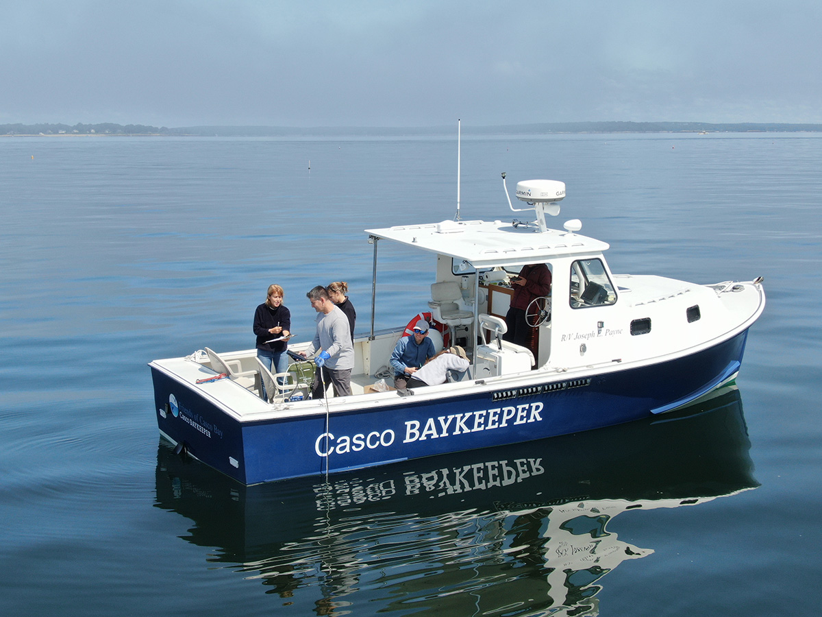 The research team collecting samples offshore from the Casco Baykeeper boat