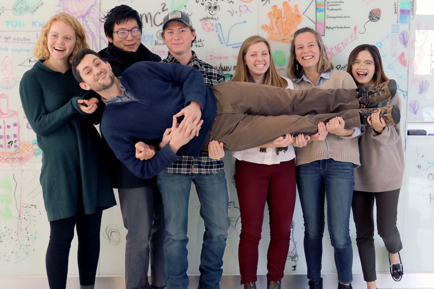 Students holding up instructor