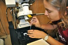 Student using lab instrument.