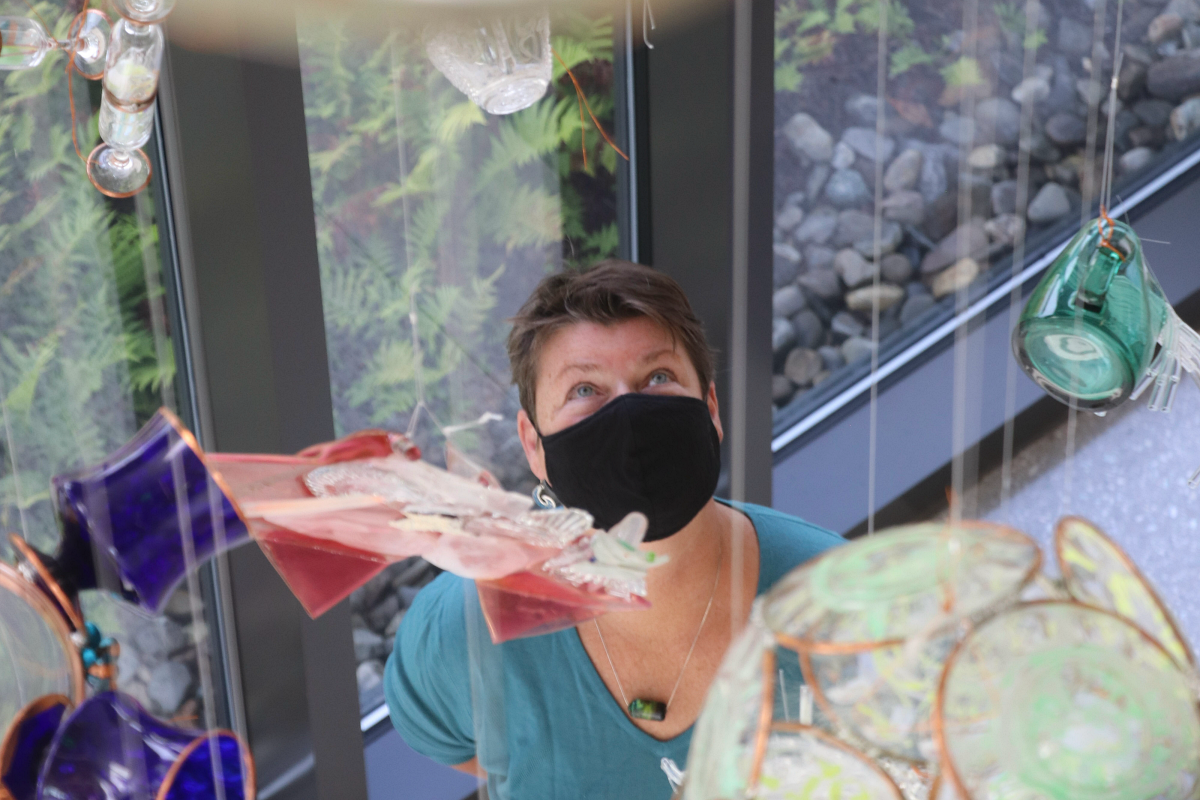 Artist viewing her work suspended above her head