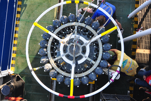 Researchers ready sensing equipment on the deck of a ship