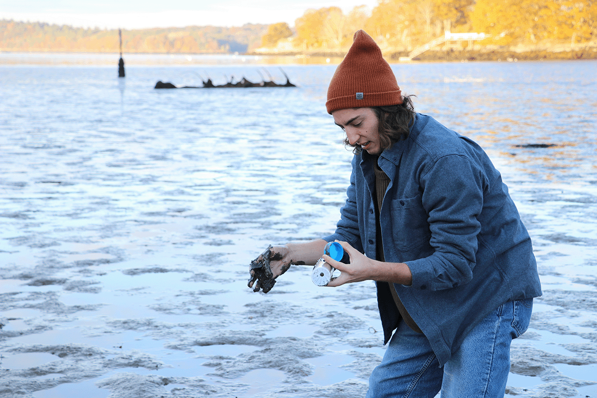 Bigelow semester student collecting sediment sample