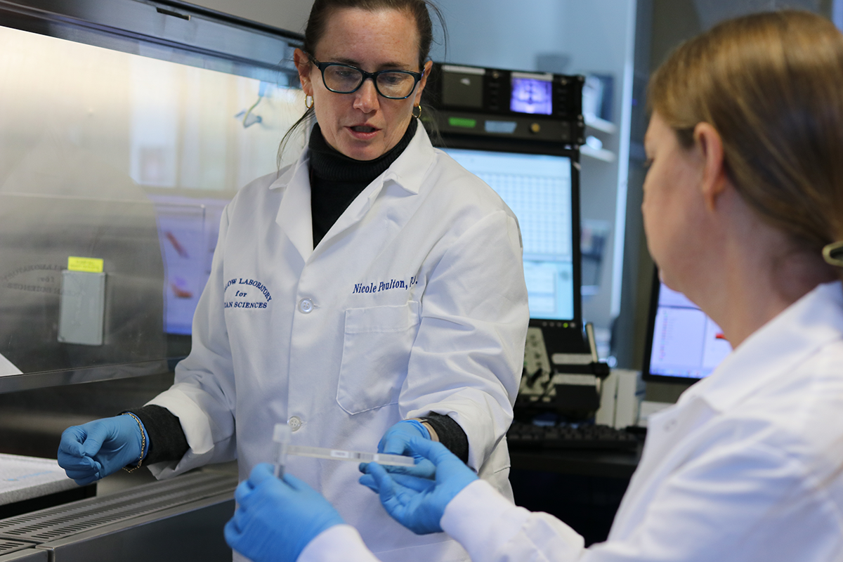 Research technician Caitlyn Olson collecting water samples