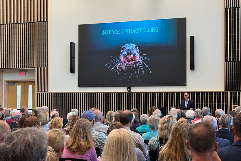 a view of THe Burgess forum with one of Brian Skerry's images on a large video screen next to Brian Skerry