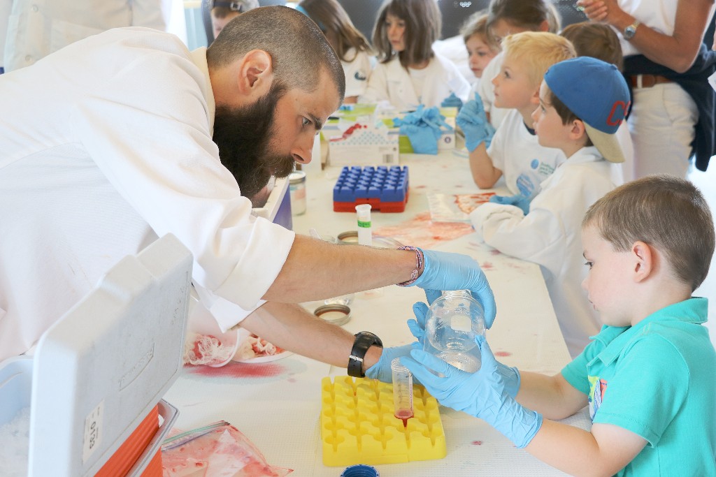 Scientist showing student experiment.