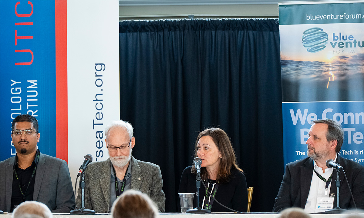 person holding a lobster in their hand and pointing to evidence of Epizootic shell disease 