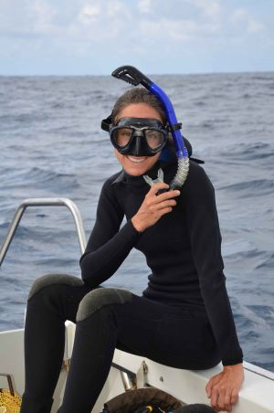 Dr. Nicole Price on boat with snorkle and scuba mask