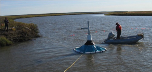 Scientist on small boat performing an experiment.