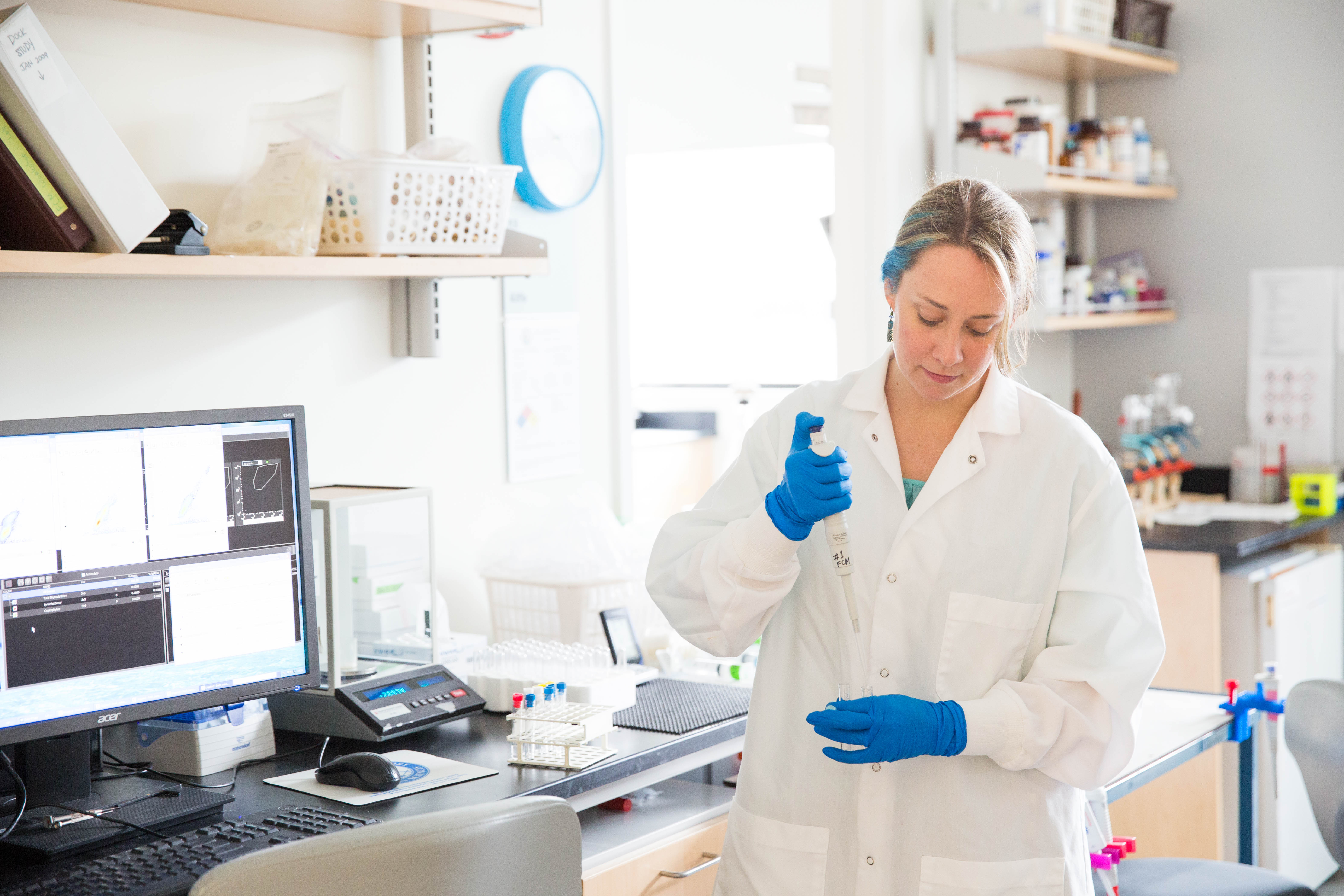 Research associate Laura Lubelczyk working in lab.